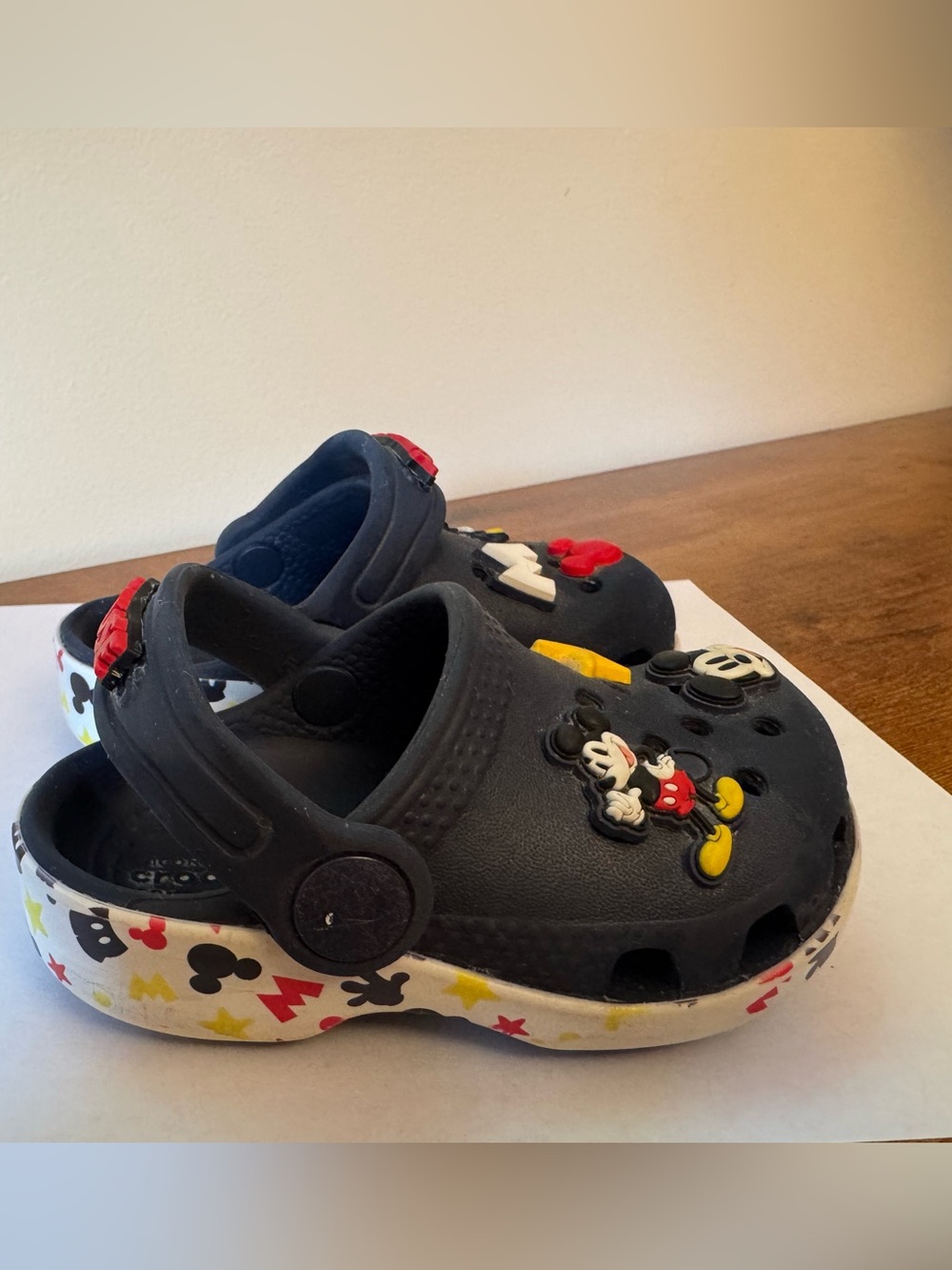 Authentic Crocs toddler clogs in navy blue with fun Mickey Mouse/Disney charms.